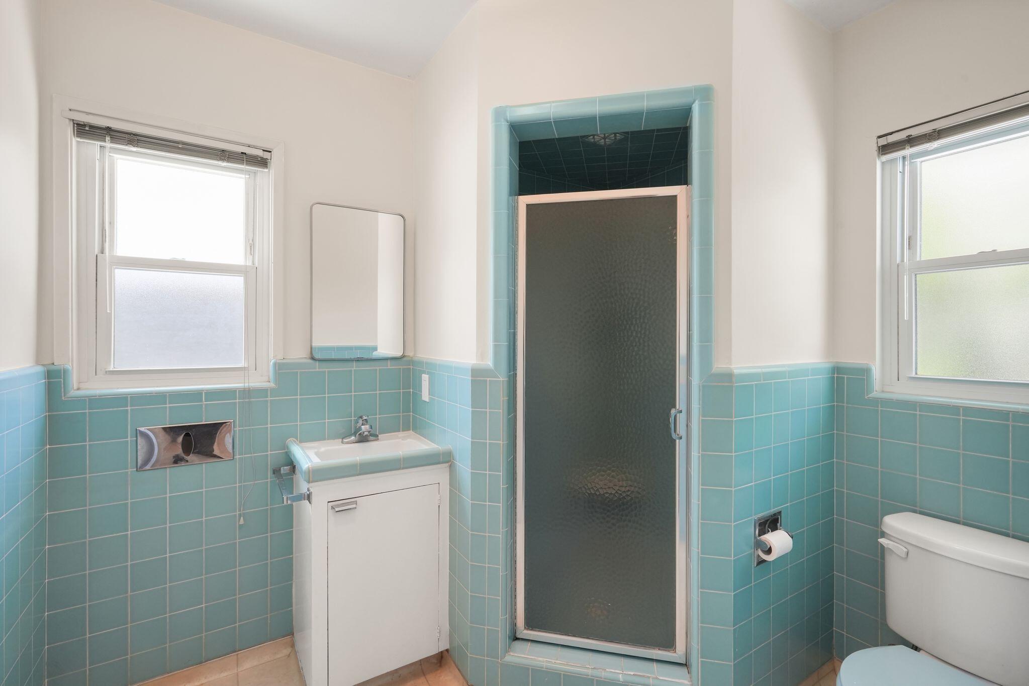 108 West Kenneth Road Glendale, CA 91202 - Photo 40 of 47 a bathroom with a toilet sink and mirror
