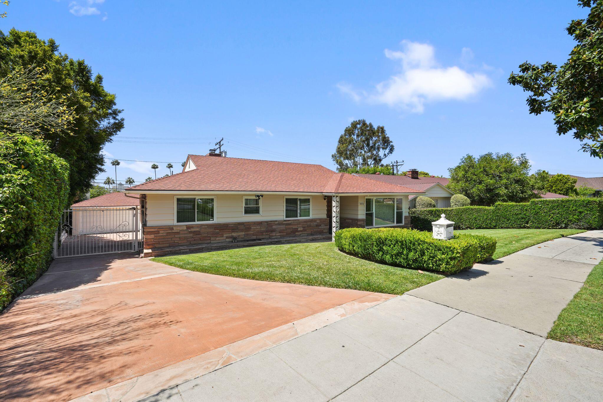 108 West Kenneth Road Glendale, CA 91202 - Photo 4 of 47 a view of house with garden and tall tress