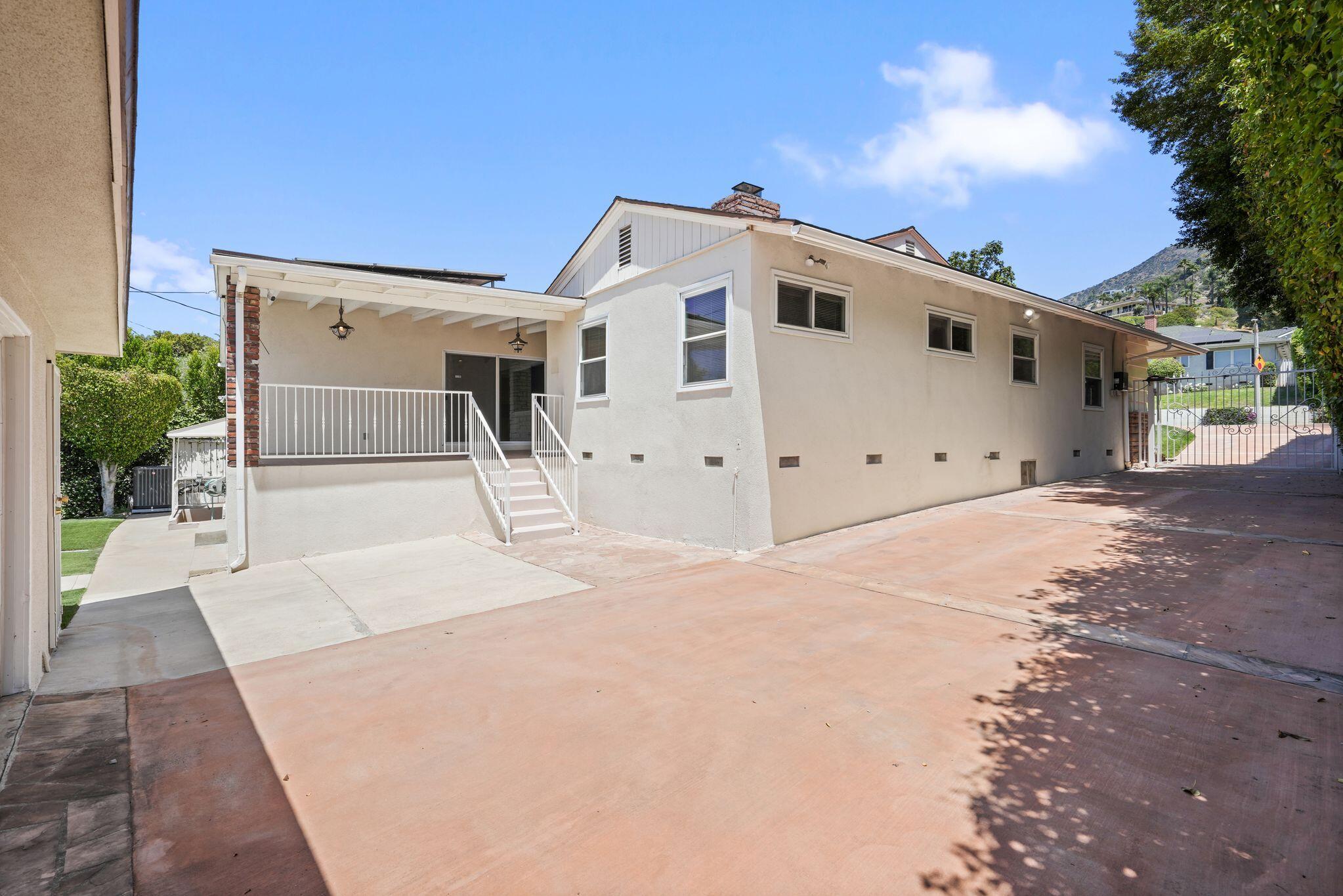 108 West Kenneth Road Glendale, CA 91202 - Photo 44 of 47 a view of a white house with a large space and a yard