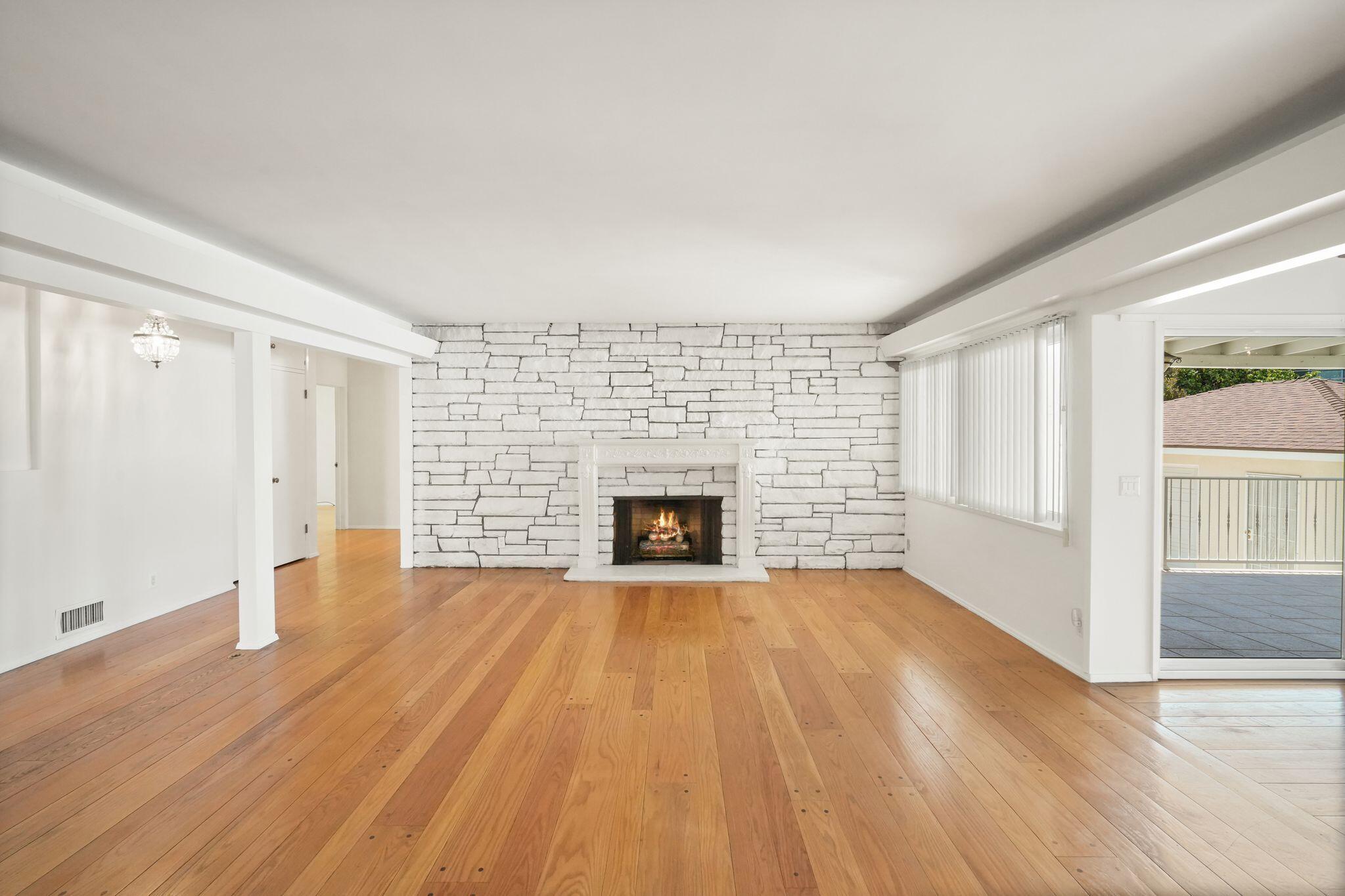 108 West Kenneth Road Glendale, CA 91202 - Photo 9 of 47 wooden floor fireplace and windows in an empty room