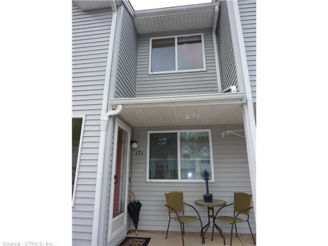 155 Redstone Hill Road, Unit 171 Bristol, CT 06010 - Photo 1 of 1 a view of a house with two chairs and a table