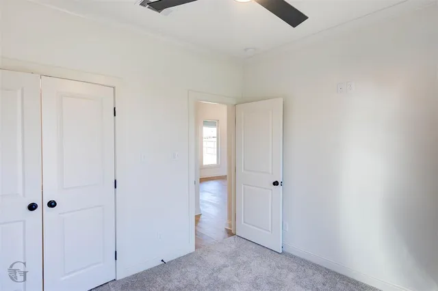 an empty room with closet area