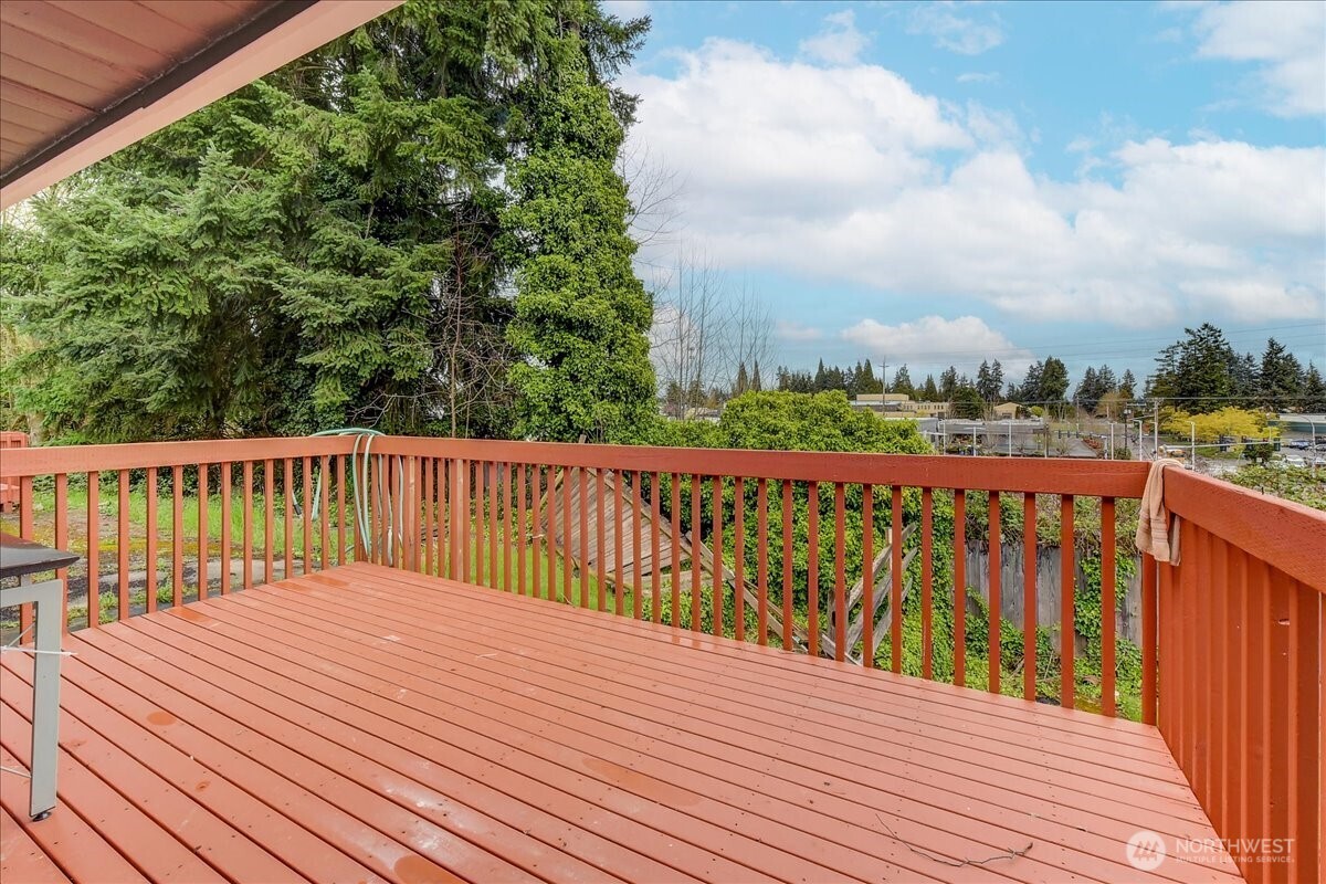 6629 204th Street Southwest Lynnwood, WA 98036 - Photo 14 of 17 a balcony with wooden floor and fence