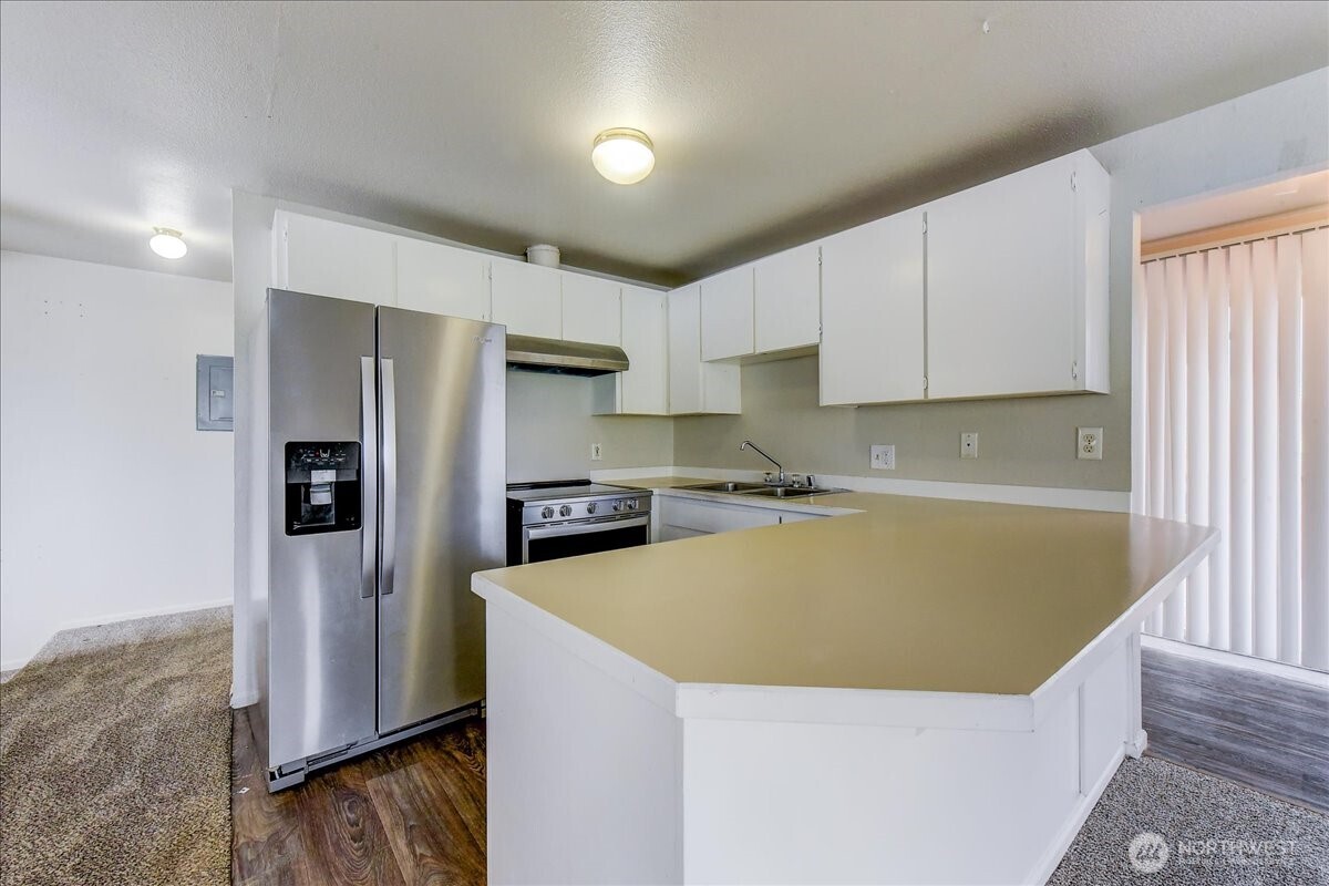 6629 204th Street Southwest Lynnwood, WA 98036 - Photo 5 of 17 a kitchen with stainless steel appliances a refrigerator and a stove