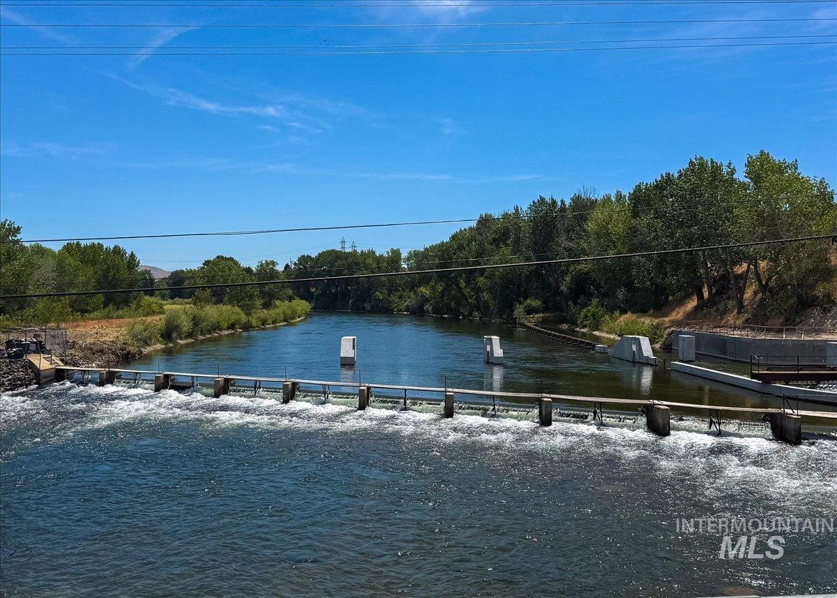 3794 South Single Tree Avenue Boise, ID 83716 - Photo 48 of 50 River with a dam structure and concrete features, bordered by abundant mature trees and natural vegetation