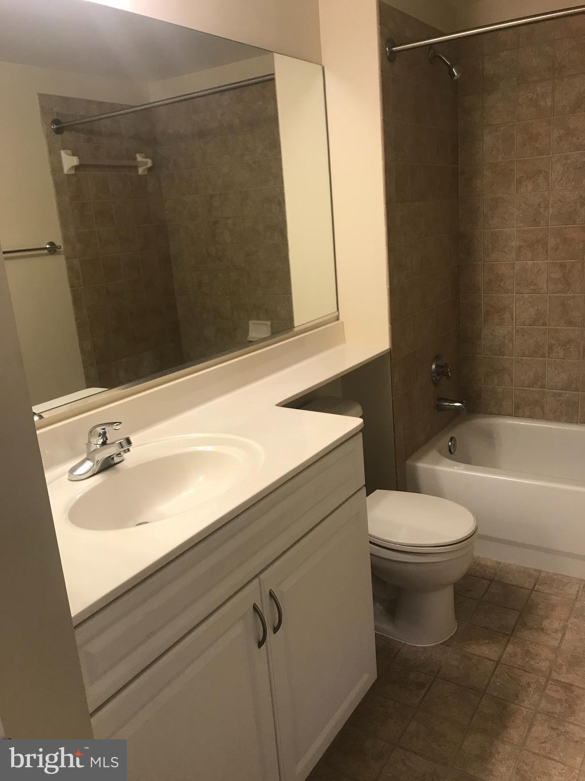555 Massachusetts Avenue Northwest, Unit 1008 Washington, DC 20001 - Photo 11 of 15 a bathroom with a sink a toilet and shower