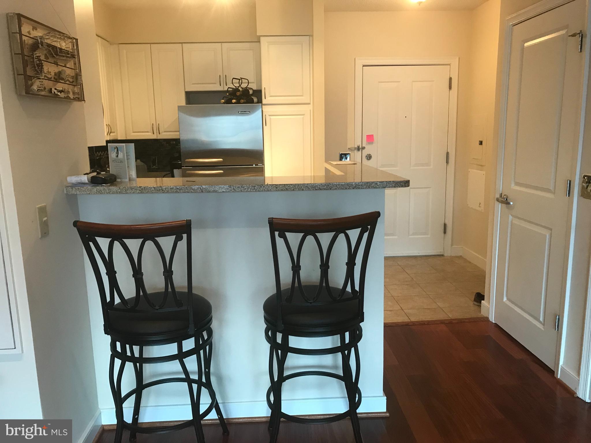 555 Massachusetts Avenue Northwest, Unit 1008 Washington, DC 20001 - Photo 5 of 15 a dining room with furniture and wooden floor