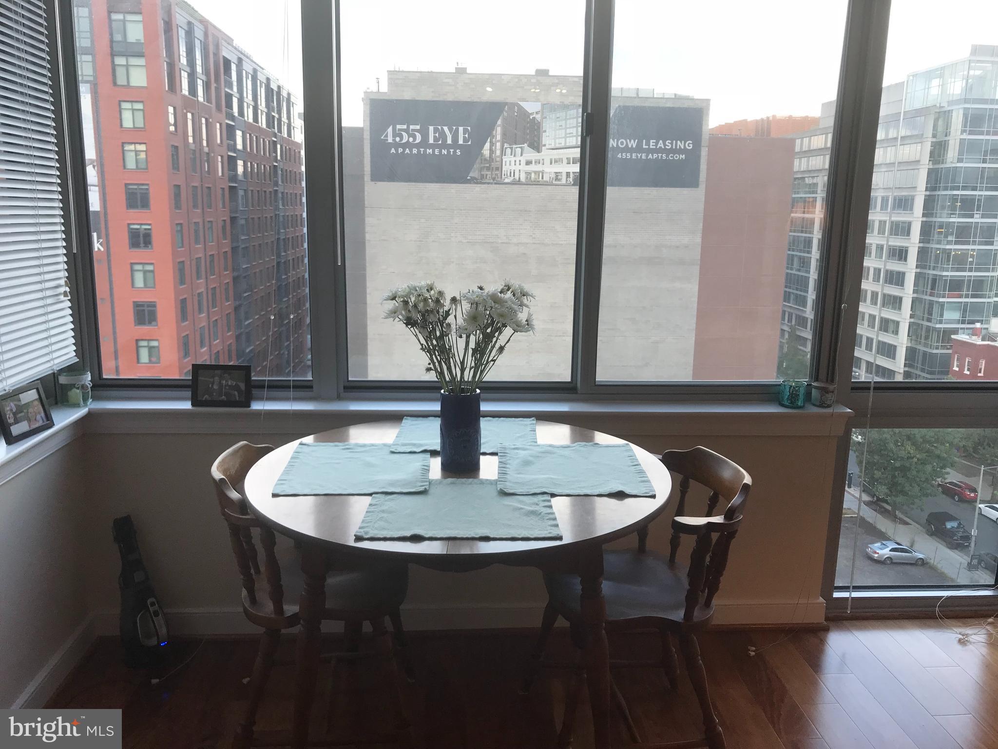 555 Massachusetts Avenue Northwest, Unit 1008 Washington, DC 20001 - Photo 7 of 15 a dining table with chairs and a table