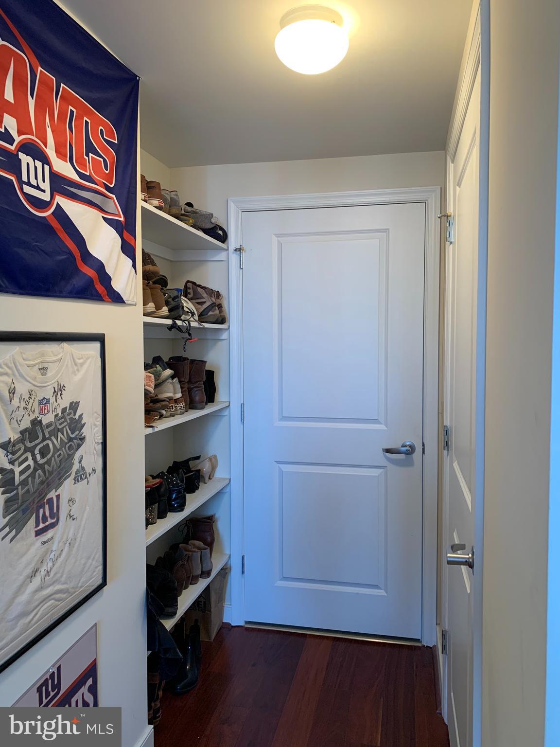 555 Massachusetts Avenue Northwest, Unit 1008 Washington, DC 20001 - Photo 10 of 15 a view of walk in closet with clothes and shoes