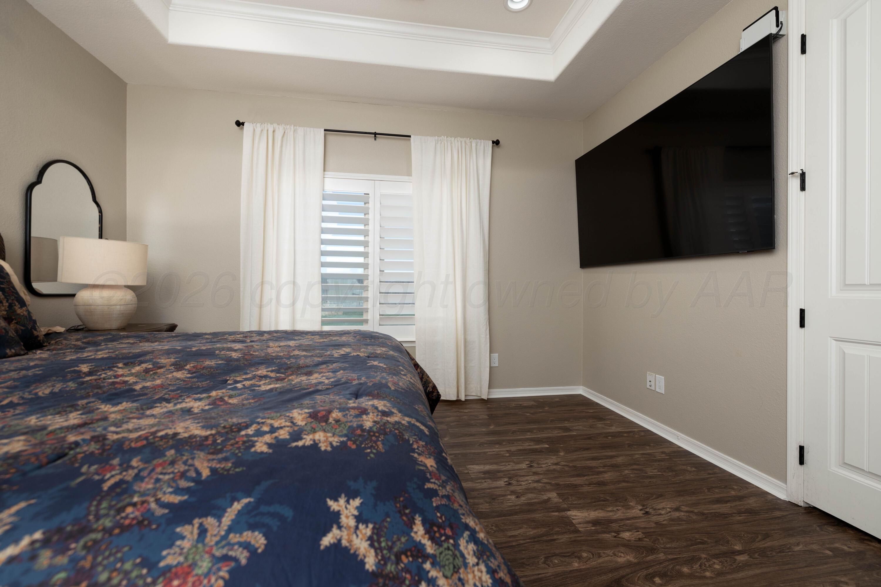 15201 Helium Road Amarillo, TX 79119 - Photo 21 of 61 a bedroom with a bed and a flat screen tv