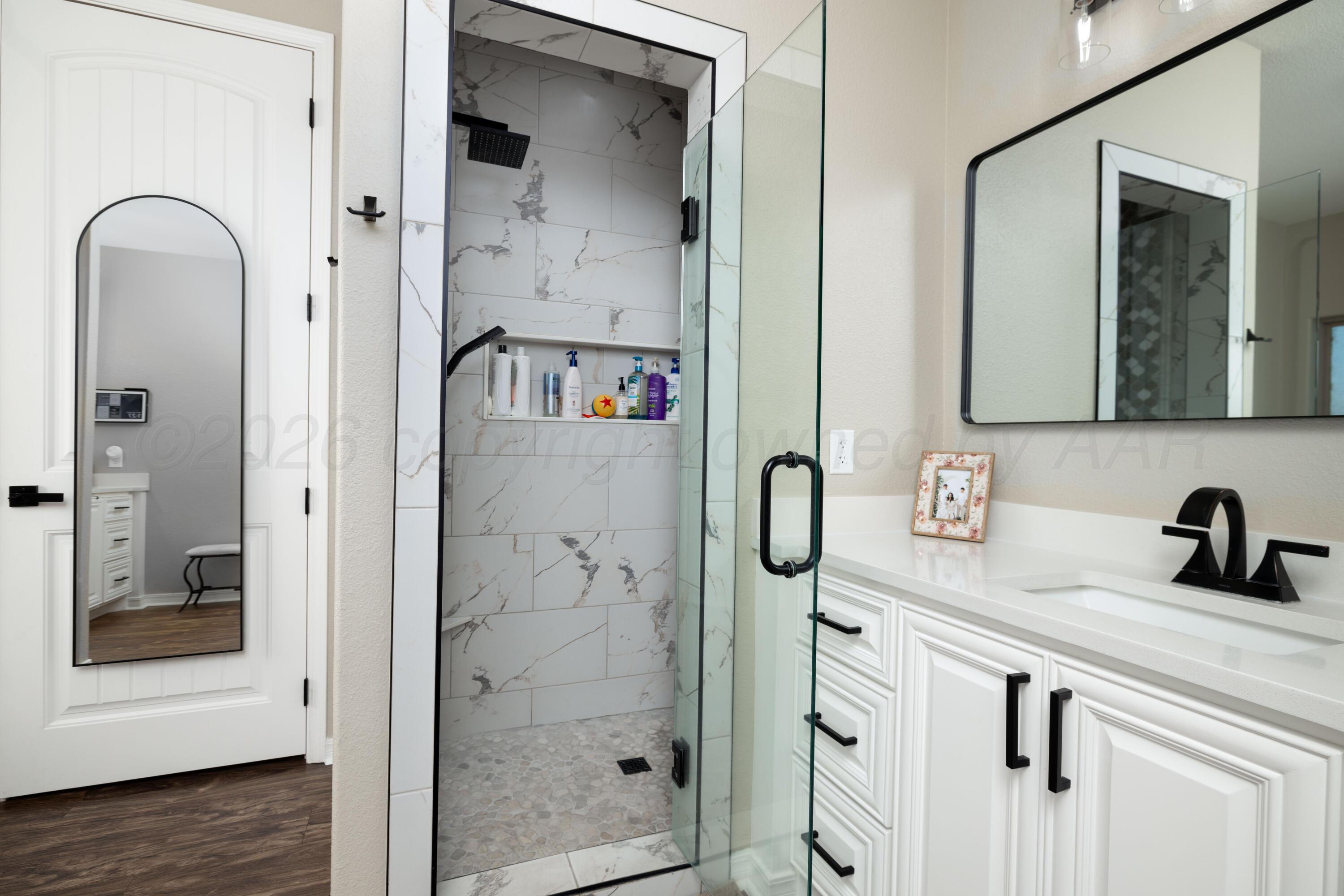 15201 Helium Road Amarillo, TX 79119 - Photo 25 of 61 a bathroom with a sink and a mirror