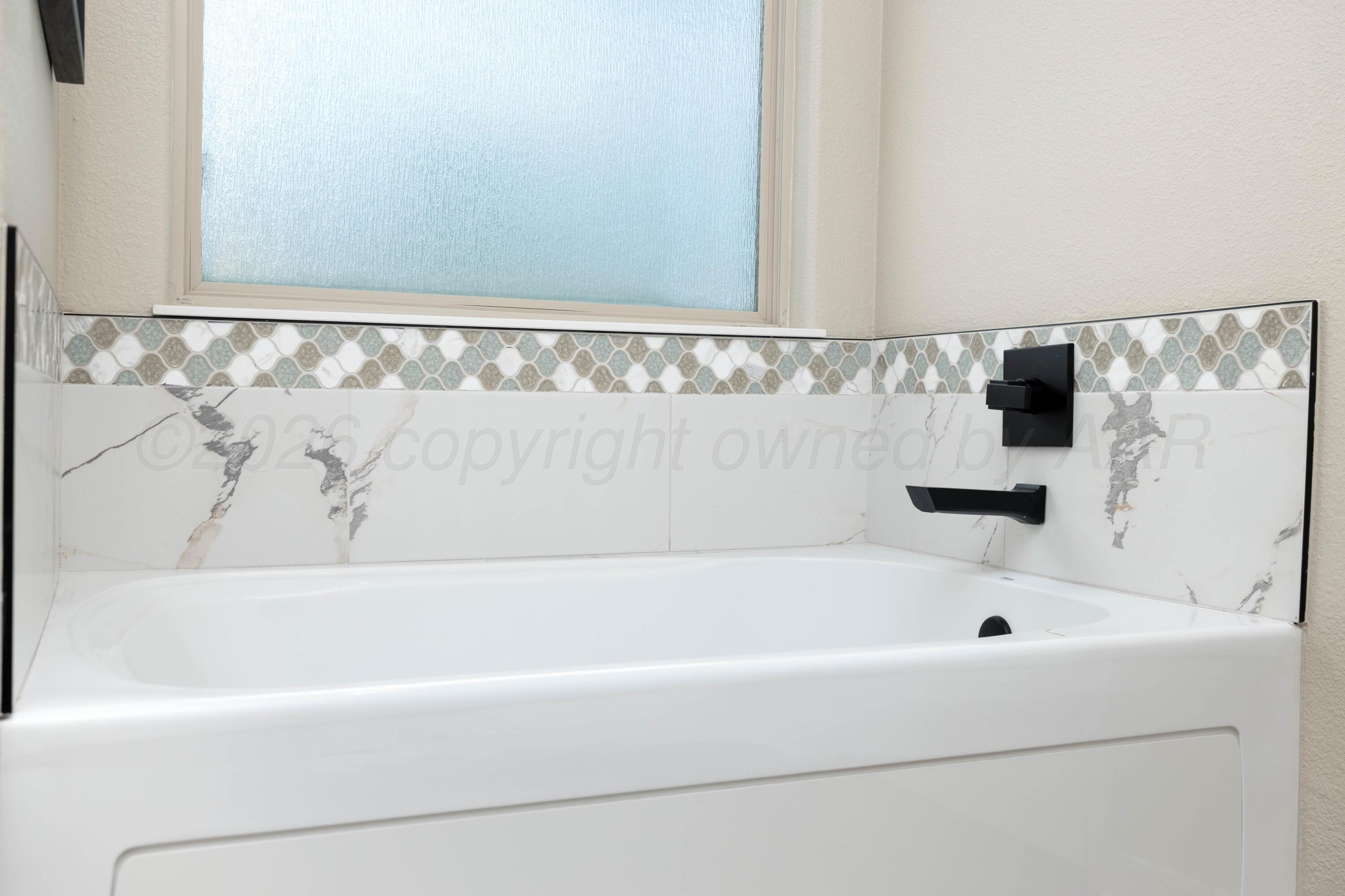 15201 Helium Road Amarillo, TX 79119 - Photo 26 of 61 a bathroom with a bathtub and shower