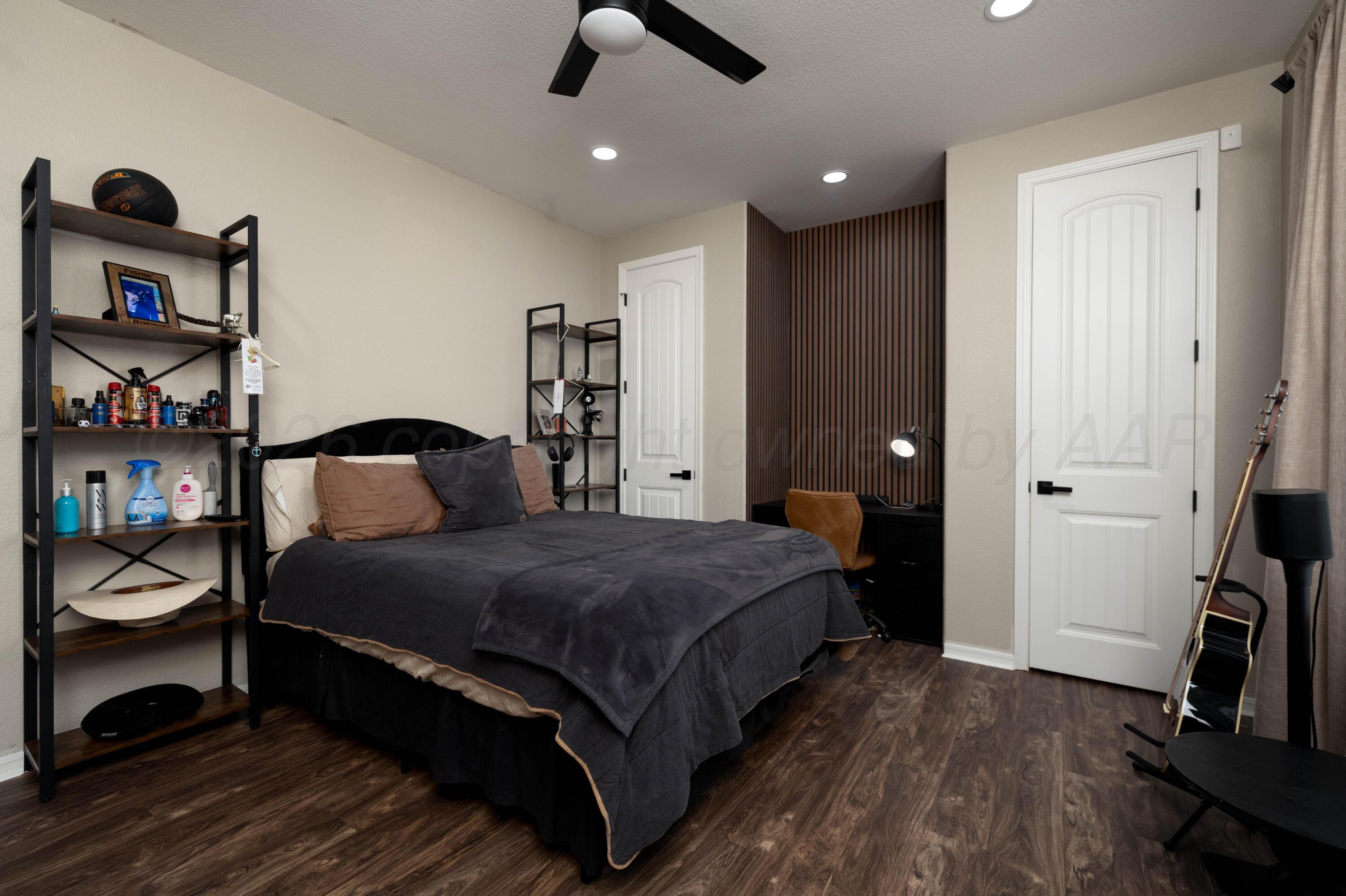 15201 Helium Road Amarillo, TX 79119 - Photo 28 of 61 a bedroom with a bed and a book shelf