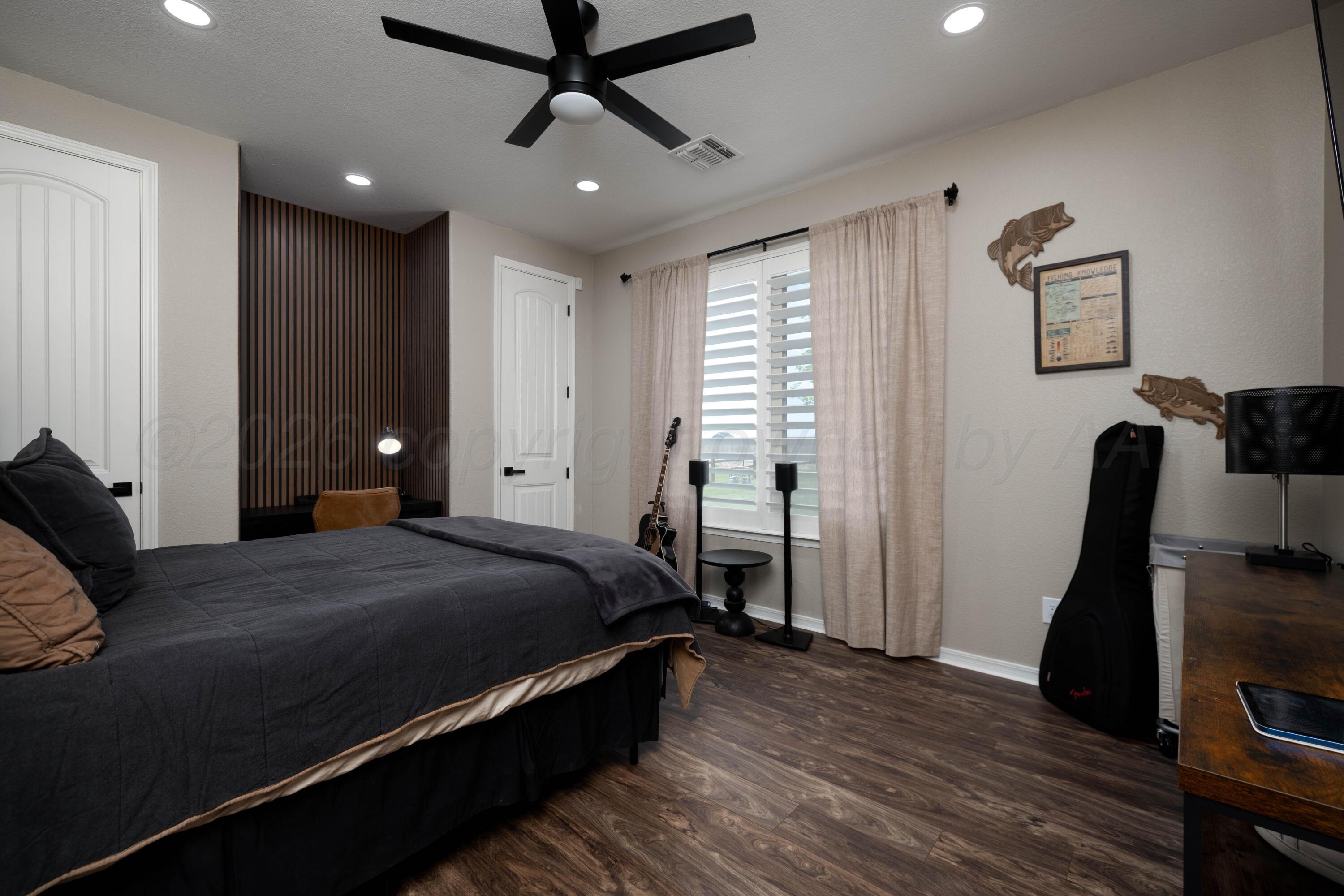 15201 Helium Road Amarillo, TX 79119 - Photo 29 of 61 a bedroom with a bed and a walk in closet