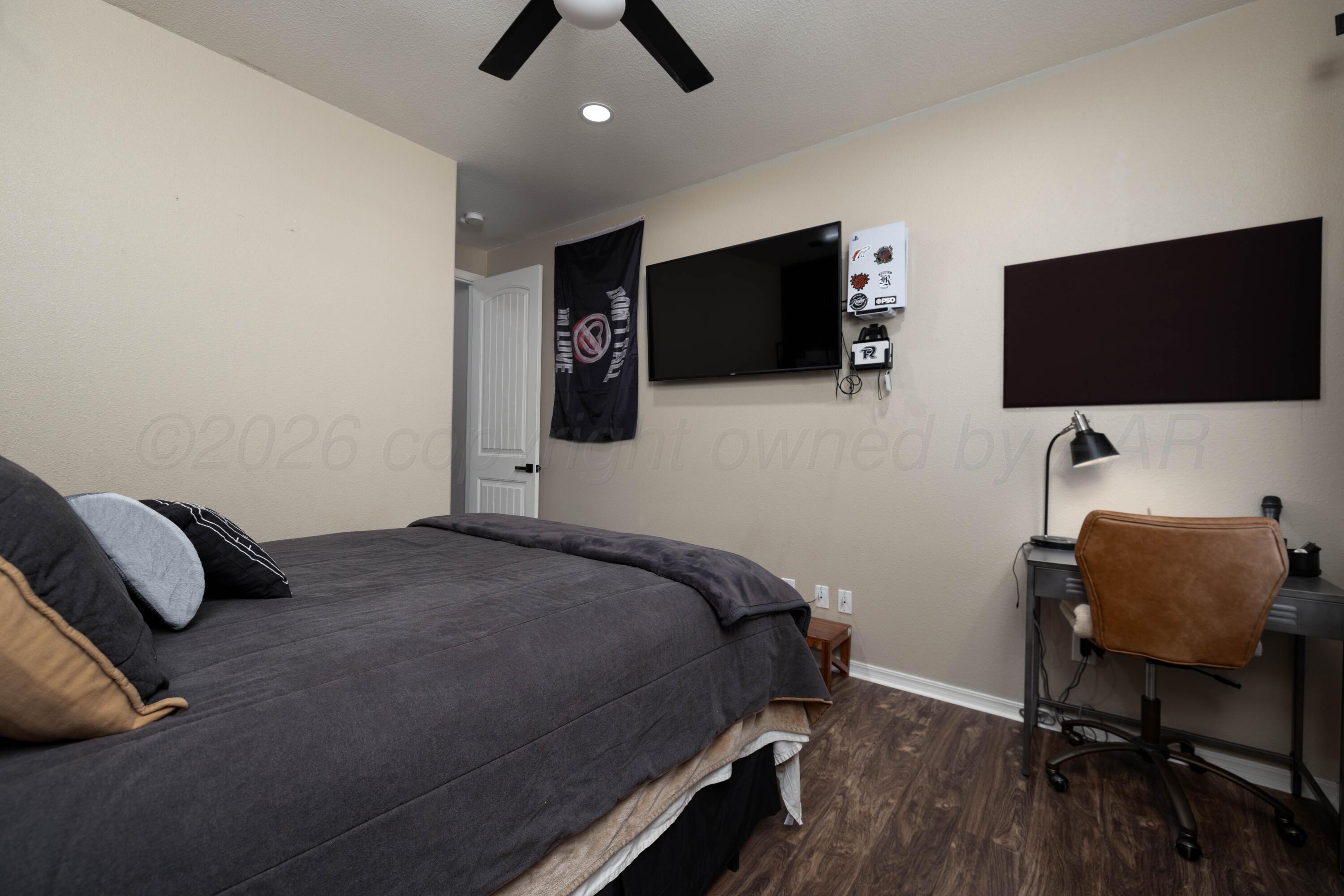 15201 Helium Road Amarillo, TX 79119 - Photo 34 of 61 a bedroom with a bed and a flat screen tv