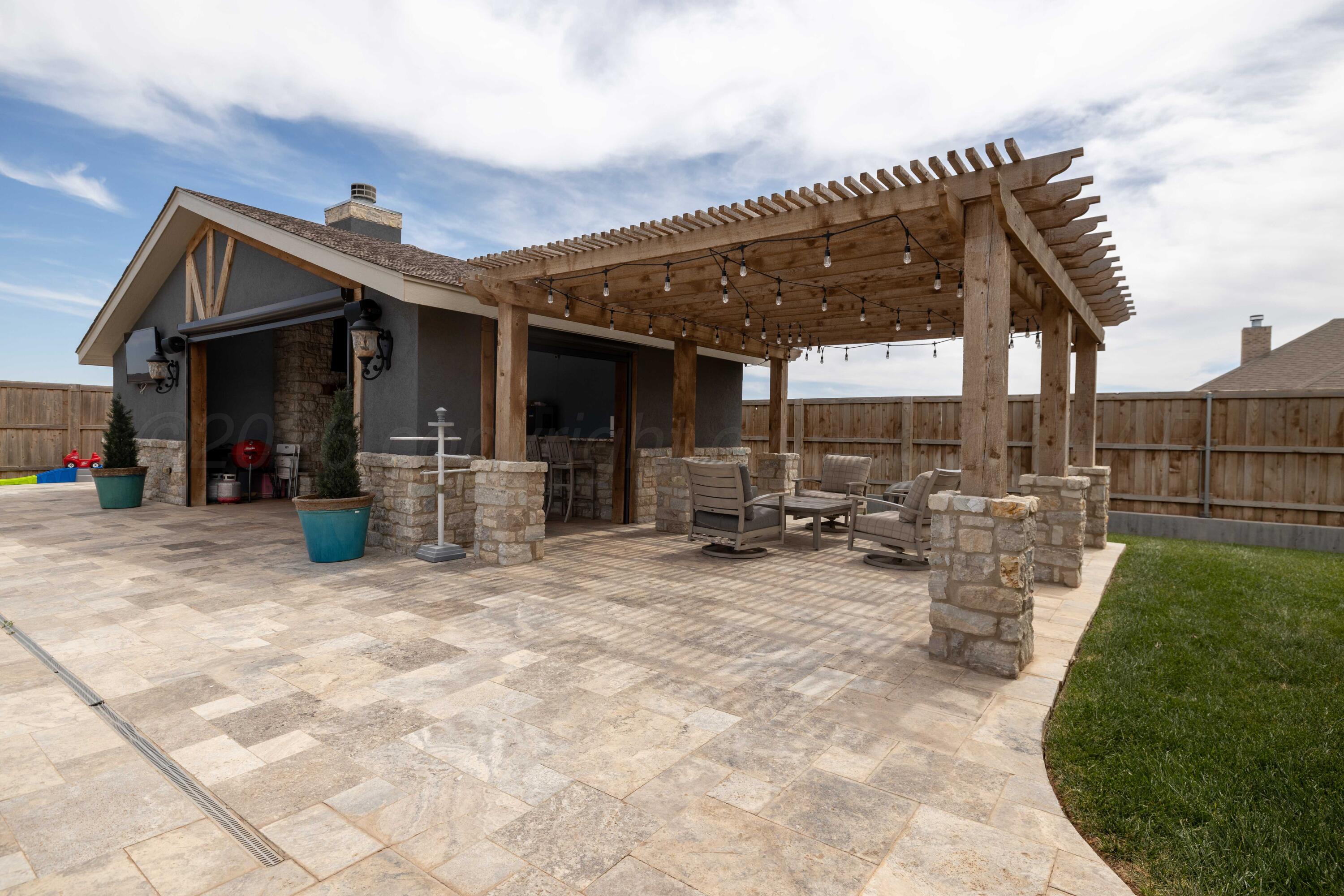 15201 Helium Road Amarillo, TX 79119 - Photo 46 of 61 a view of a patio with table and chairs a barbeque with wooden fence