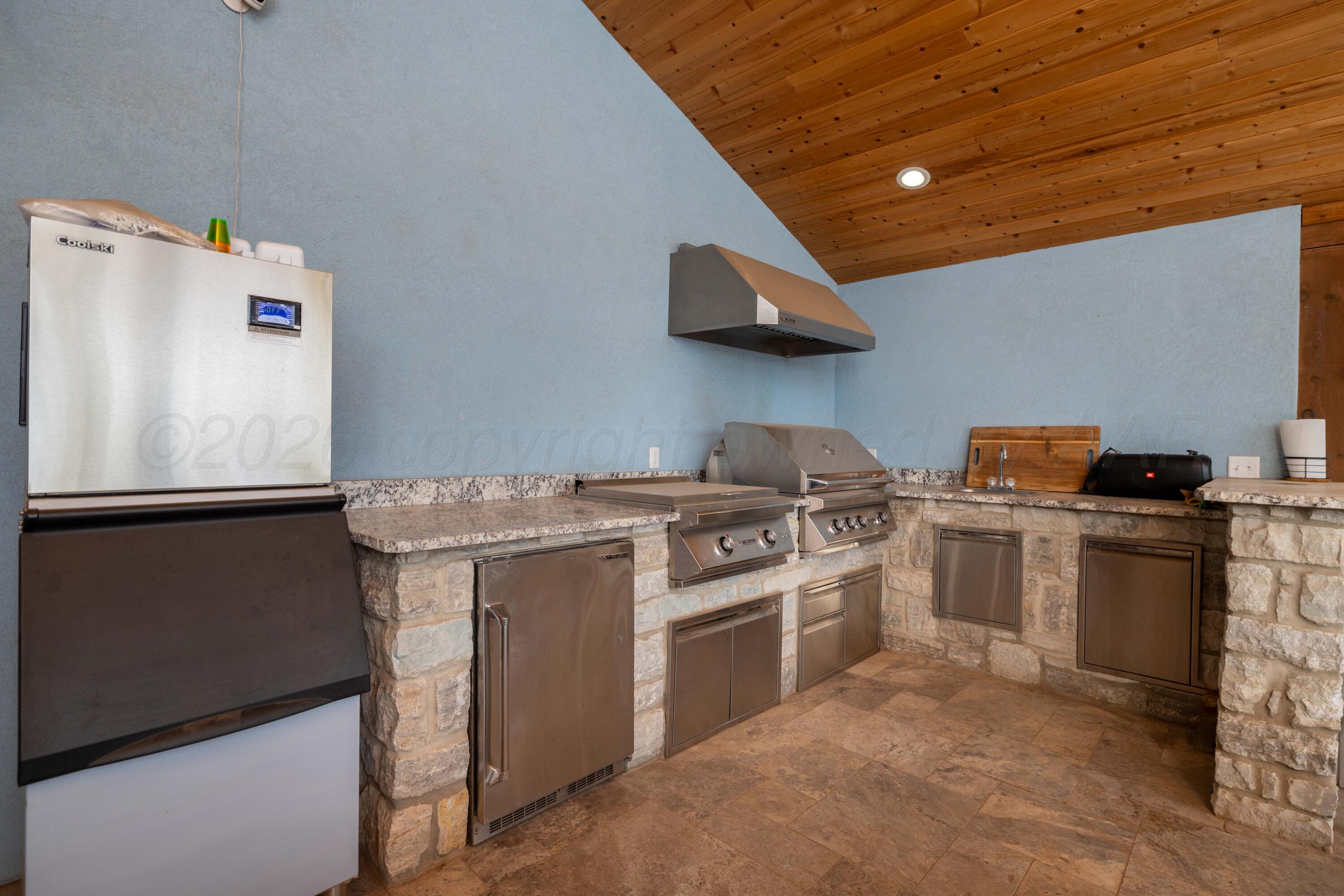 15201 Helium Road Amarillo, TX 79119 - Photo 50 of 61 a kitchen with a stove top oven and cabinets