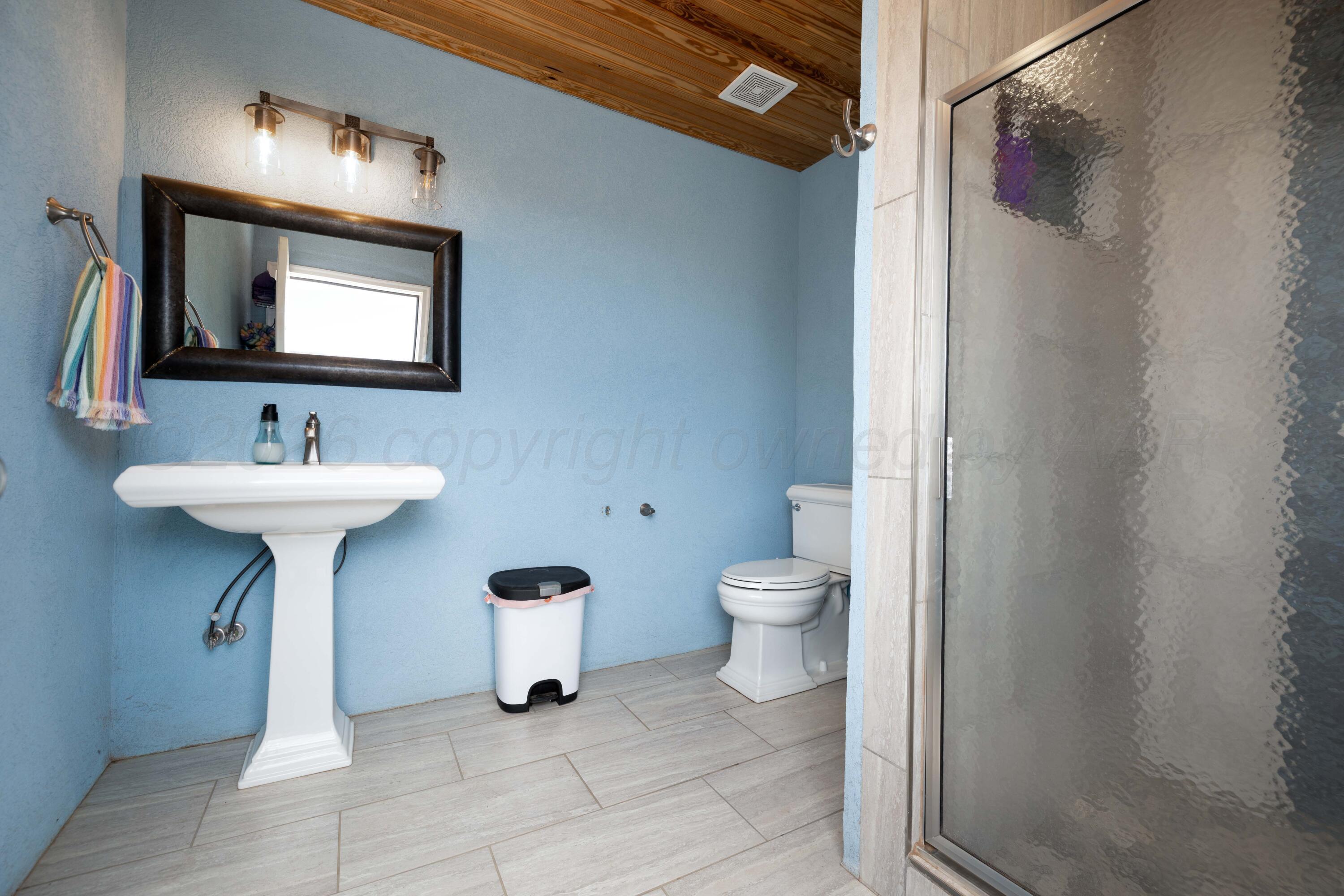 15201 Helium Road Amarillo, TX 79119 - Photo 53 of 61 a bathroom with a sink toilet and mirror