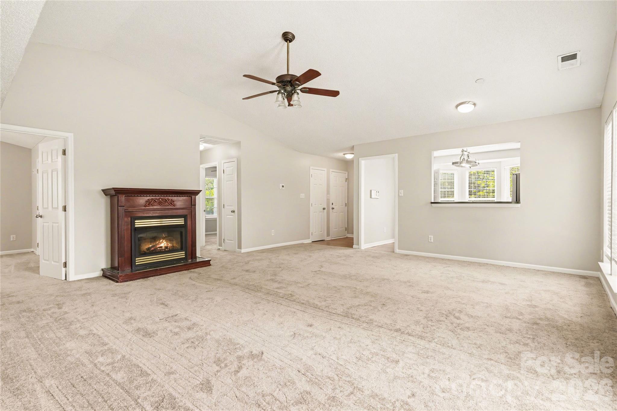117 North Tanninger Road Mount Holly, NC 28120 - Photo 2 of 10 a view of an empty room with a fireplace and a window