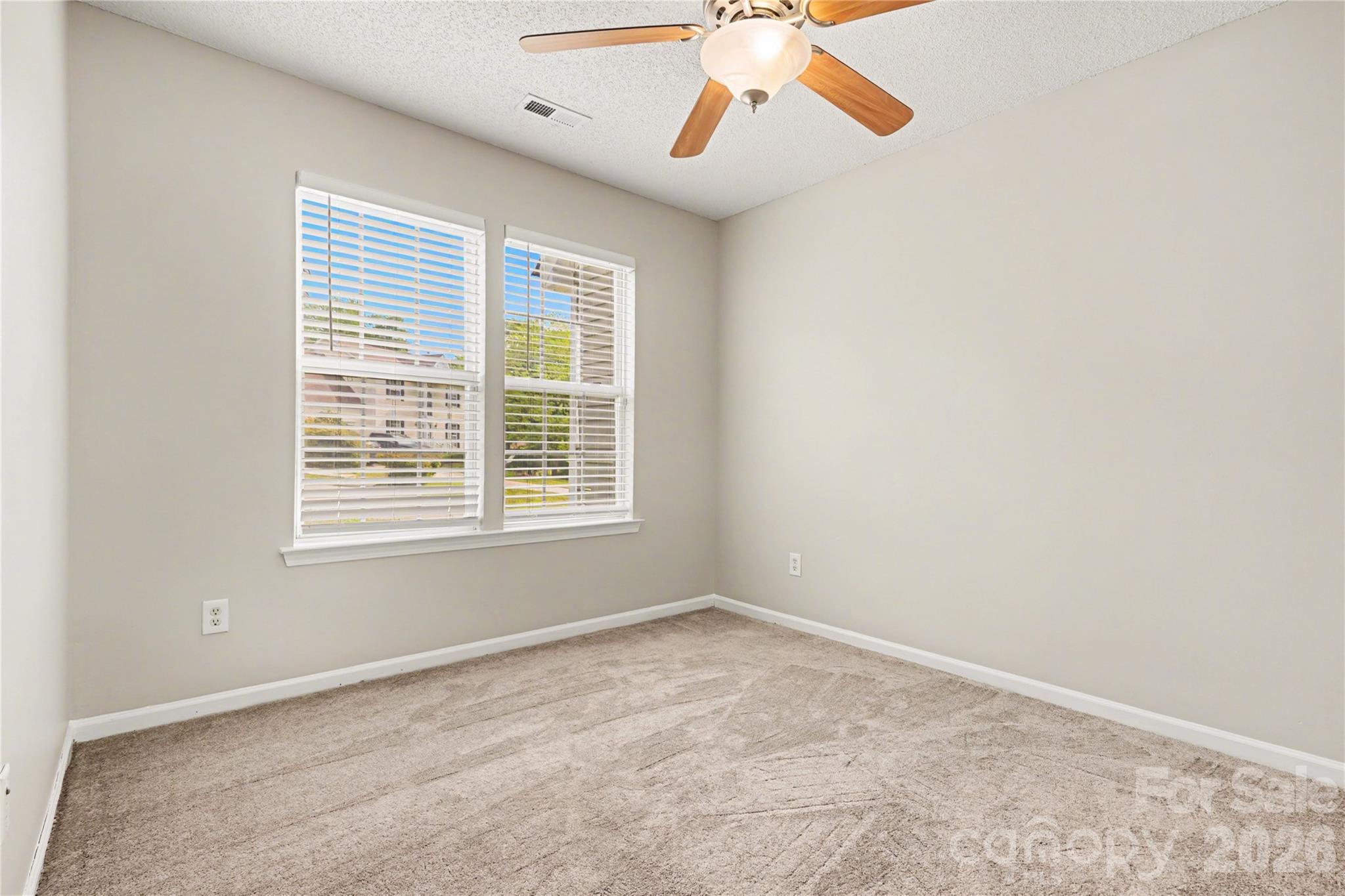 117 North Tanninger Road Mount Holly, NC 28120 - Photo 7 of 10 an empty room with windows and fan