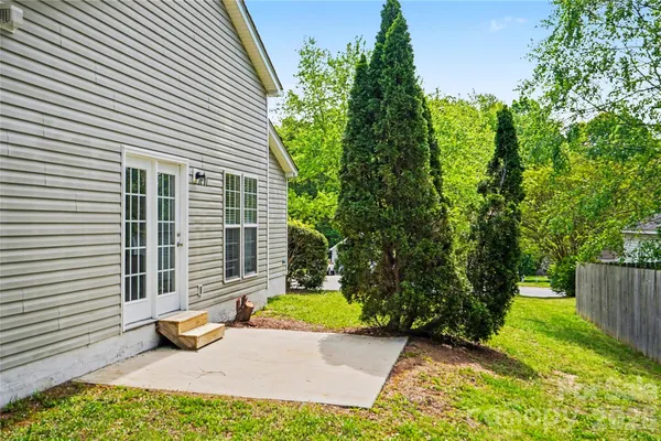 a view of a backyard with plants and a garden