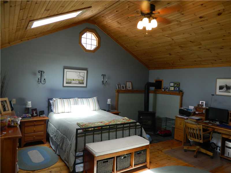 38 Pine Tree Road Coventry, RI 02816 - Photo 8 of 18 Master Bedroom. Massive Master Suite (18x18) with Gas Stove, 2 Skylights and knotty pine ceilings.