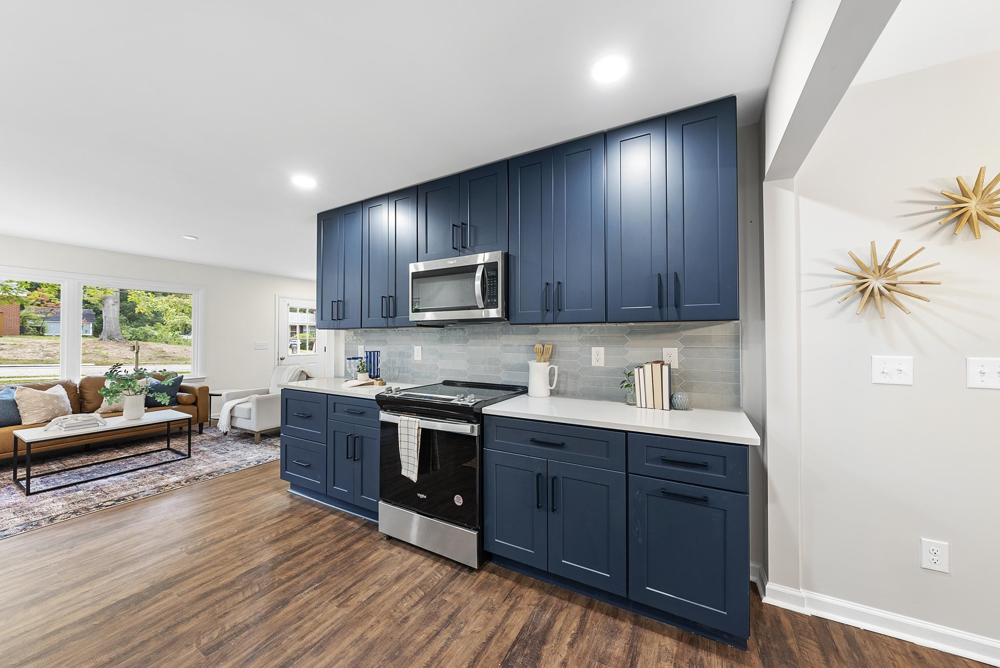 3128 Brentwood Road Raleigh, NC 27604 - Photo 11 of 28 a kitchen with wooden floors and wooden cabinets