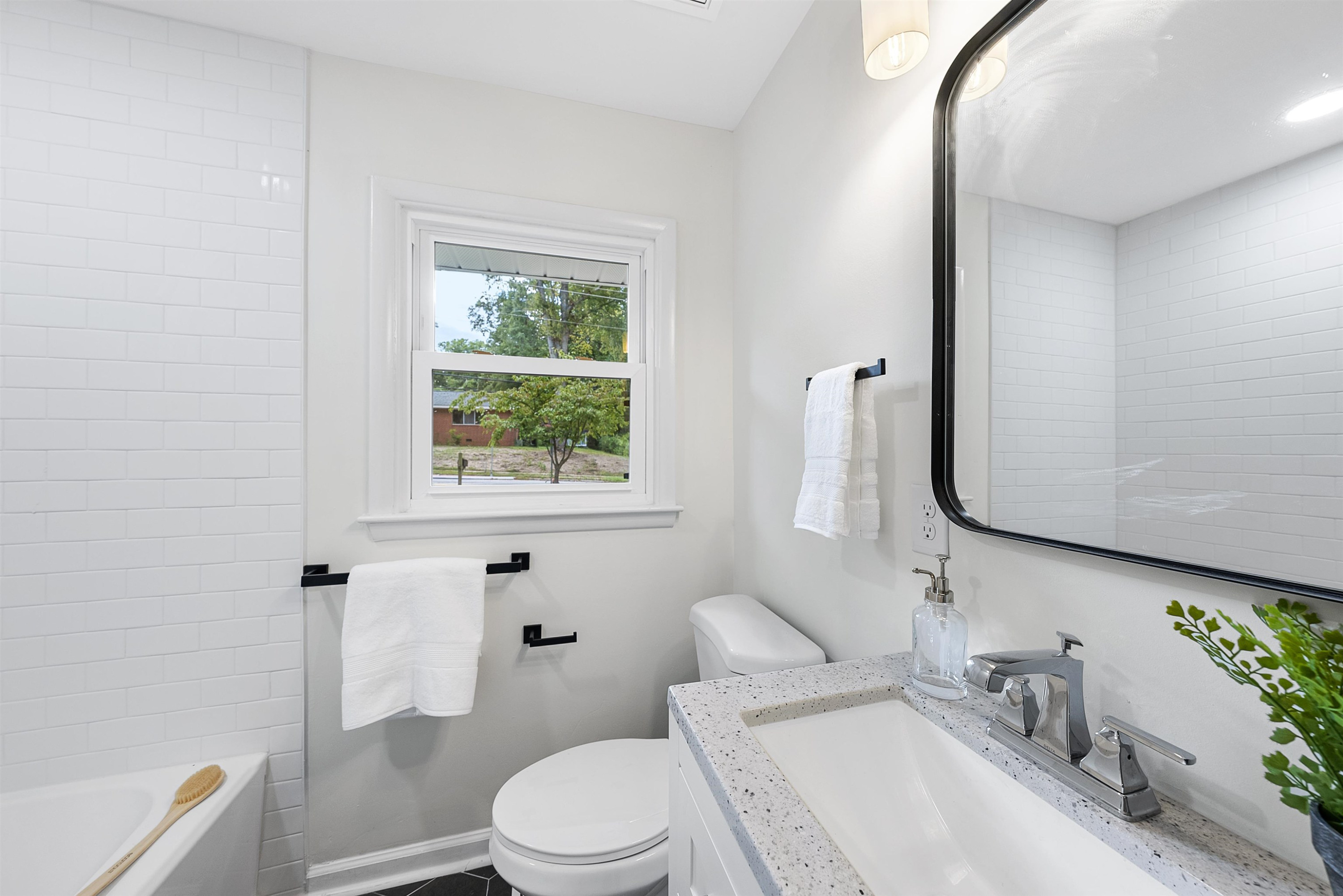 3128 Brentwood Road Raleigh, NC 27604 - Photo 19 of 28 a white toilet sitting next to a bathroom sink