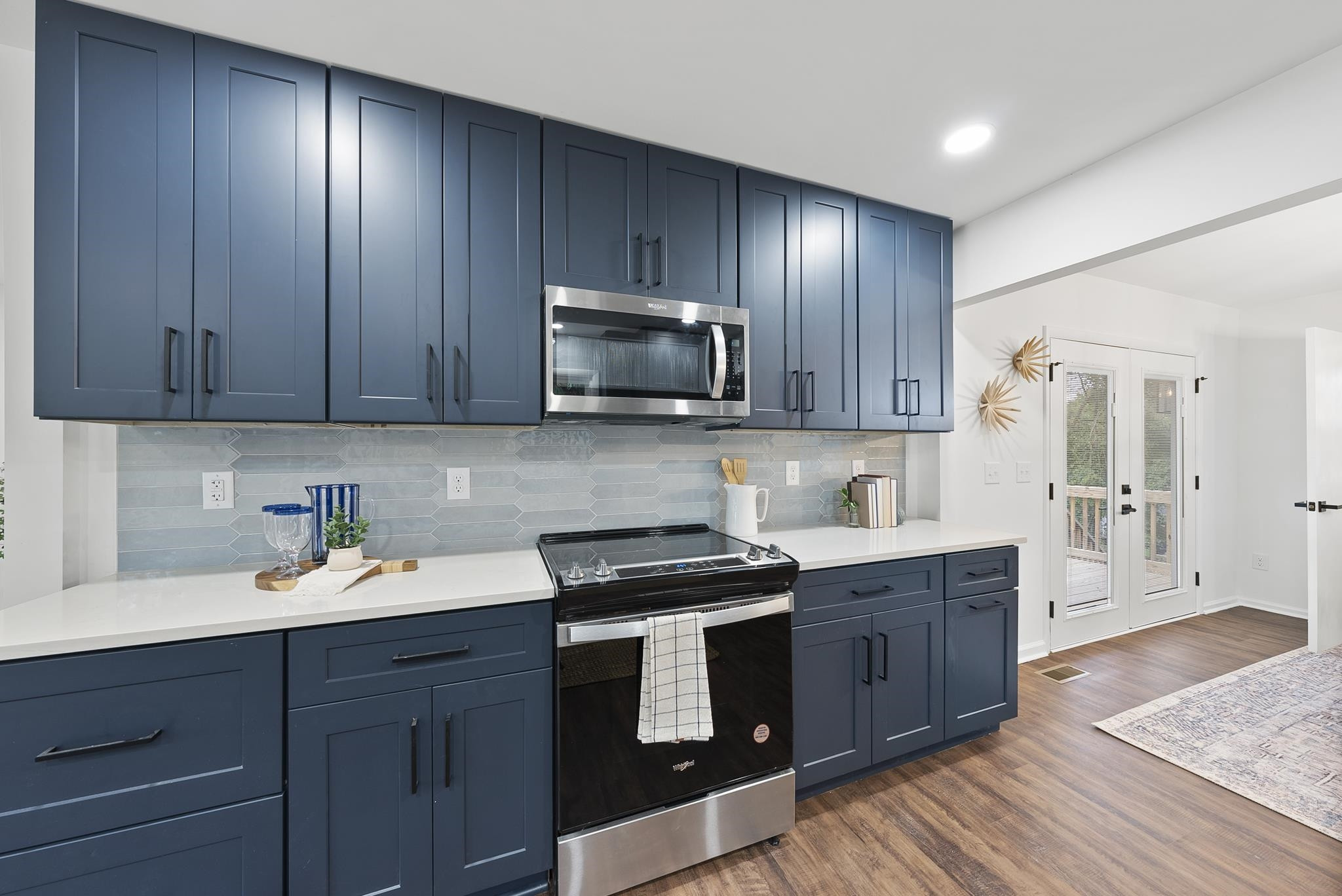 3128 Brentwood Road Raleigh, NC 27604 - Photo 8 of 28 a kitchen with stainless steel appliances granite countertop wooden cabinets and a stove top oven