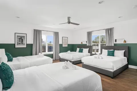 a bedroom with two beds and a large window