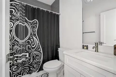 a bathroom with a sink a toilet and a mirror