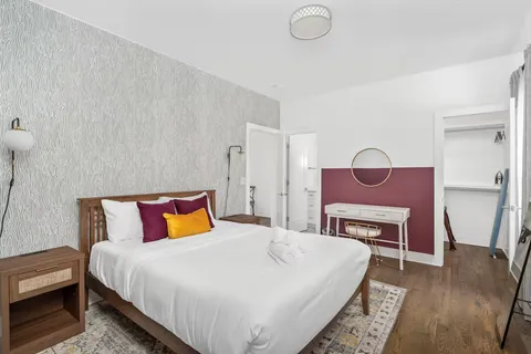 a bed room with a bed and a chair