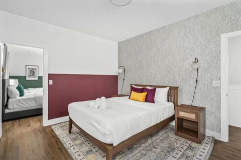 a bedroom with a bed and wooden floor