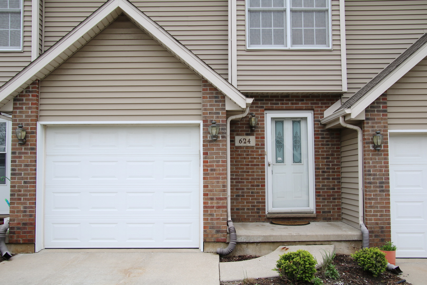 a front view of a house with a garage