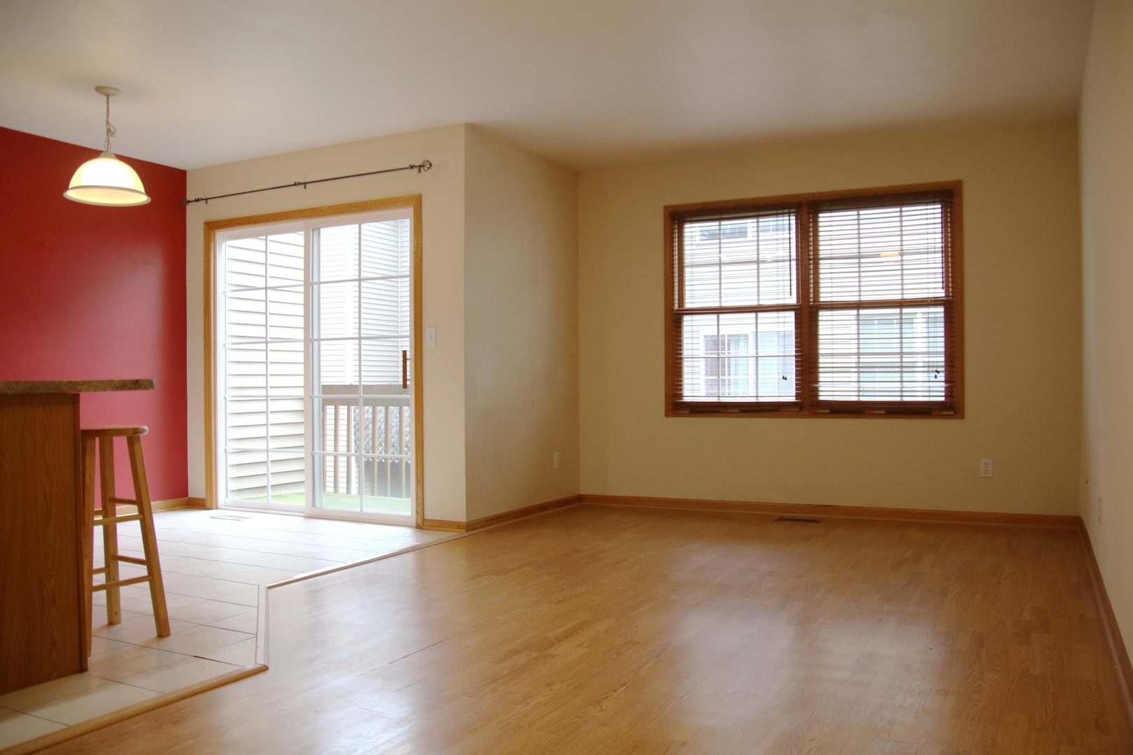 624 South Peace Road, Unit 624 Sycamore, IL 60178 - Photo 4 of 14 an empty room with wooden floor and windows