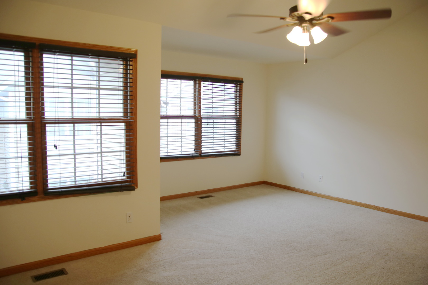 624 South Peace Road, Unit 624 Sycamore, IL 60178 - Photo 6 of 14 an empty room with a window and a fan