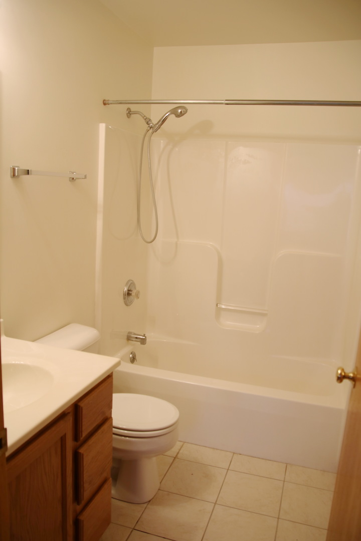 624 South Peace Road, Unit 624 Sycamore, IL 60178 - Photo 8 of 14 a bathroom with a granite countertop bathtub shower sink vanity and toilet