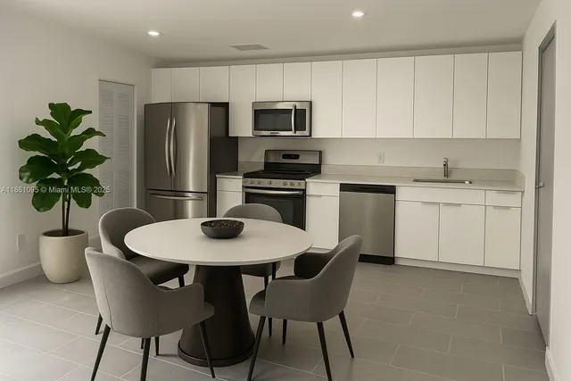 a kitchen with a table and chairs in it