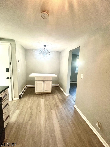 205 North 16th Street Bloomfield, NJ 07003 - Photo 2 of 6 a spacious bedroom with a bed and a table