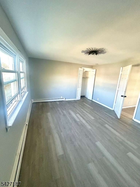 205 North 16th Street Bloomfield, NJ 07003 - Photo 6 of 6 an empty room with wooden floor and windows