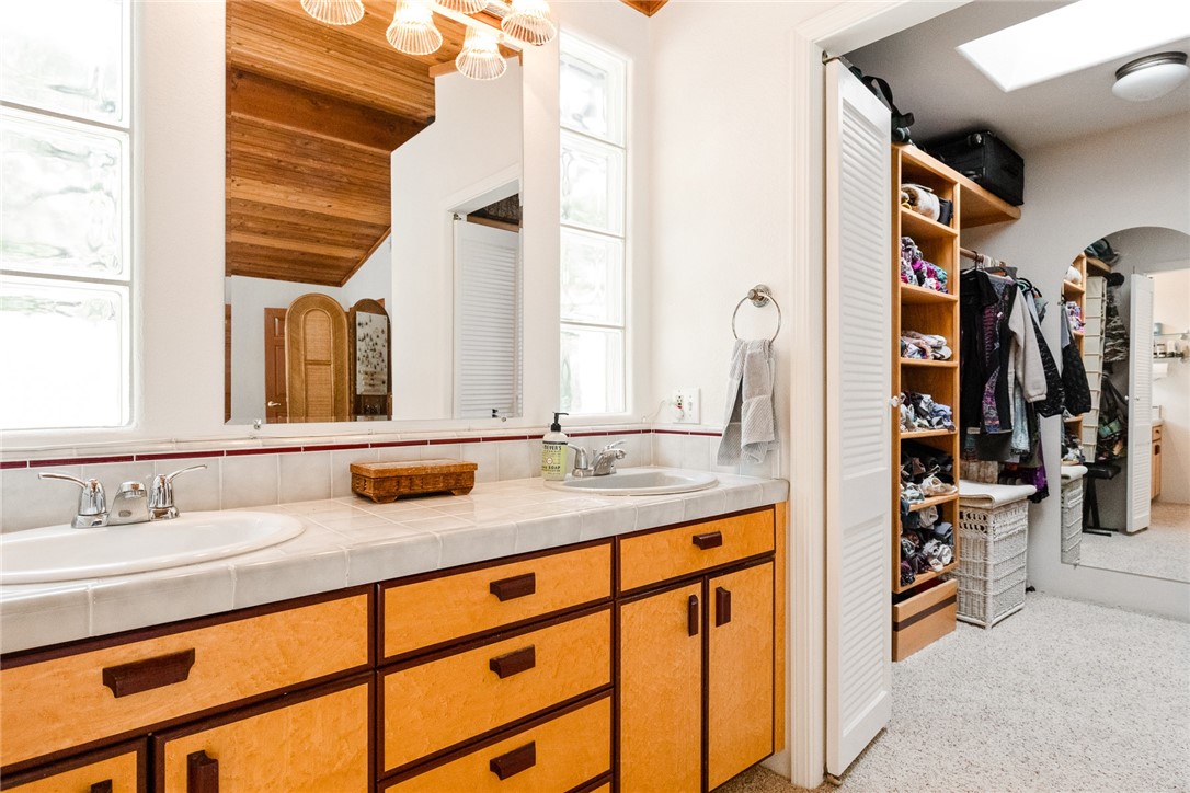 16366 Morro Road Atascadero, CA 93422 - Photo 16 of 69 a bathroom with a double vanity sink and a mirror