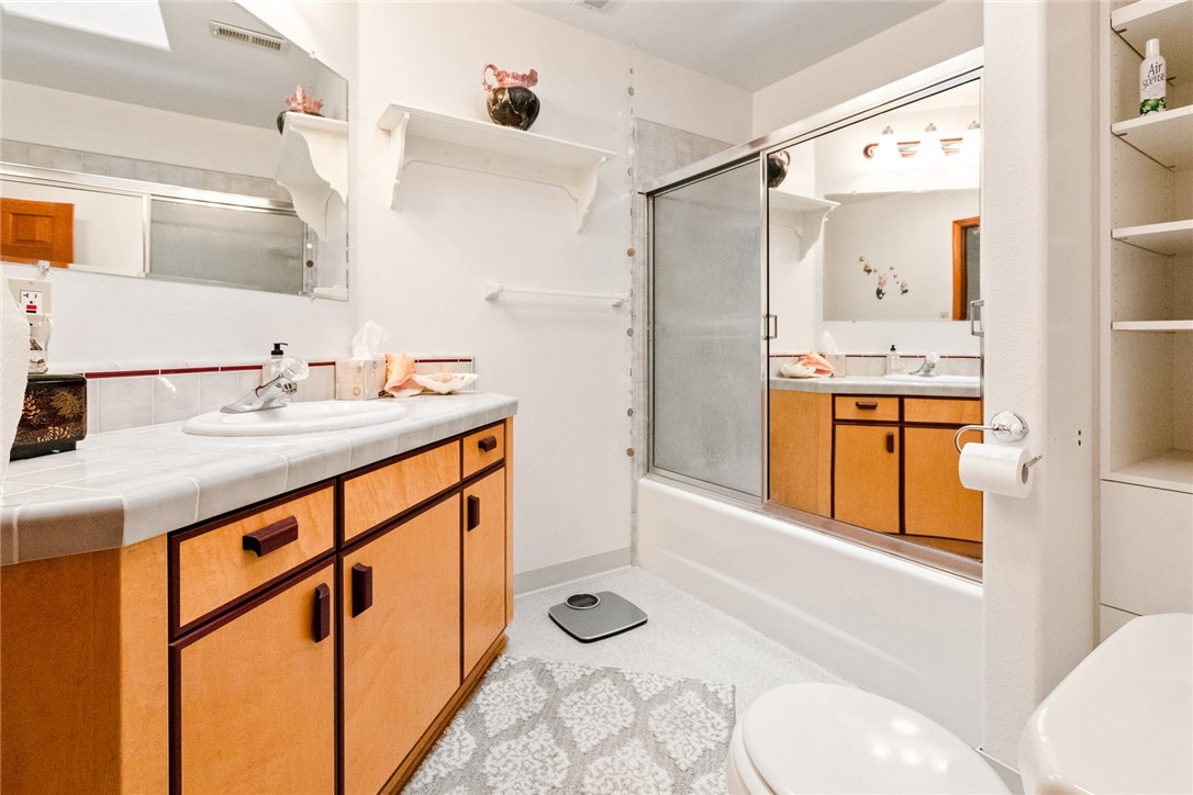 16366 Morro Road Atascadero, CA 93422 - Photo 18 of 69 a bathroom with a granite countertop sink and a mirror