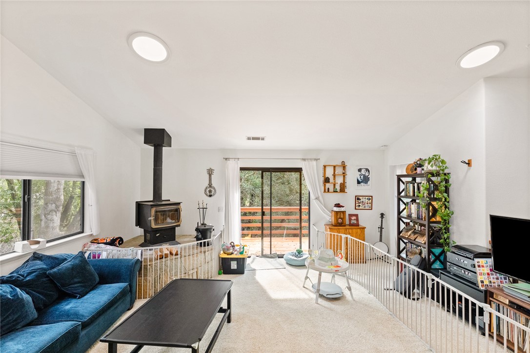 16366 Morro Road Atascadero, CA 93422 - Photo 27 of 69 a living room with furniture a flat screen tv and a large window