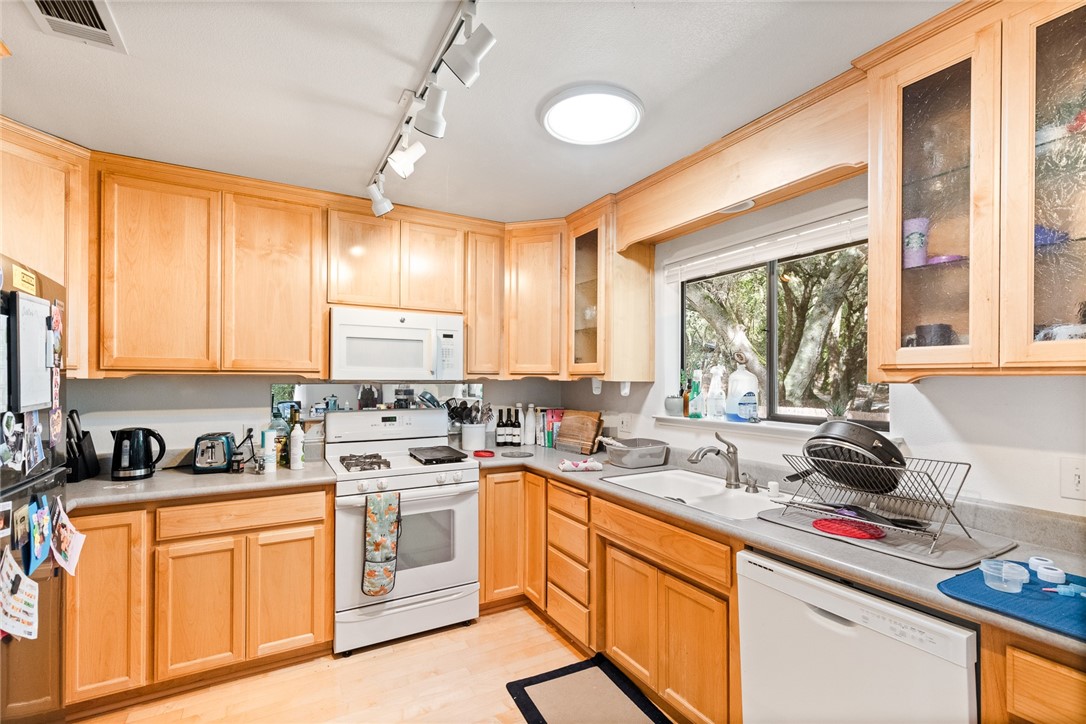 16366 Morro Road Atascadero, CA 93422 - Photo 28 of 69 a kitchen with a sink stove top oven and cabinets