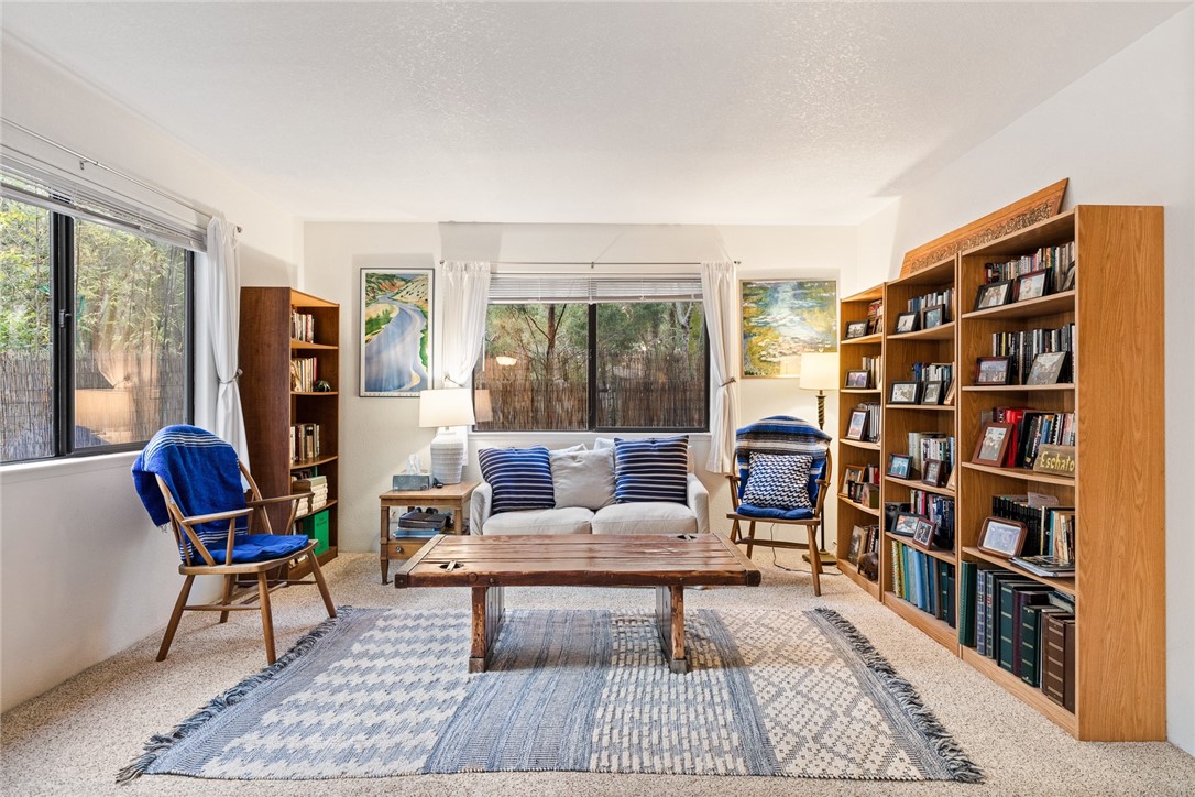 16366 Morro Road Atascadero, CA 93422 - Photo 41 of 69 a living room with furniture a rug and a book shelf