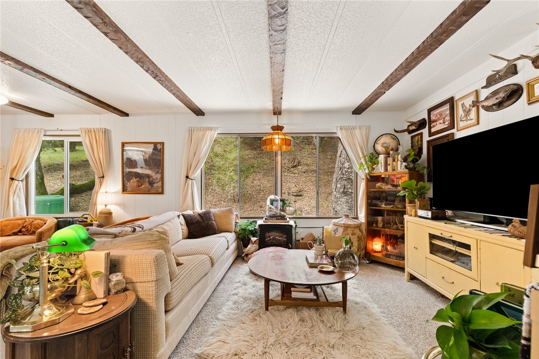 16366 Morro Road Atascadero, CA 93422 - Photo 49 of 69 a living room with furniture a flat screen tv and a large window