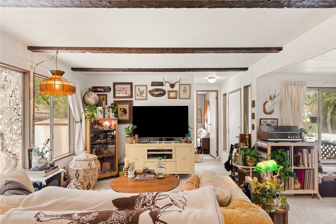16366 Morro Road Atascadero, CA 93422 - Photo 50 of 69 a living room with furniture a flat screen tv and a floor to ceiling window
