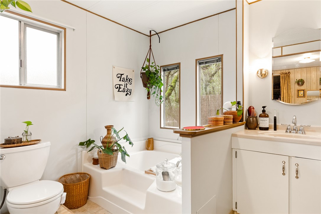 16366 Morro Road Atascadero, CA 93422 - Photo 57 of 69 a bathroom with a sink a toilet and a mirror