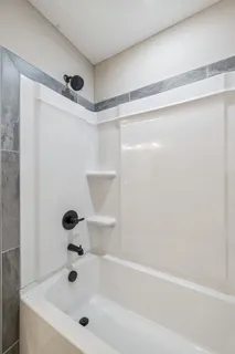 an empty room with fan and windows