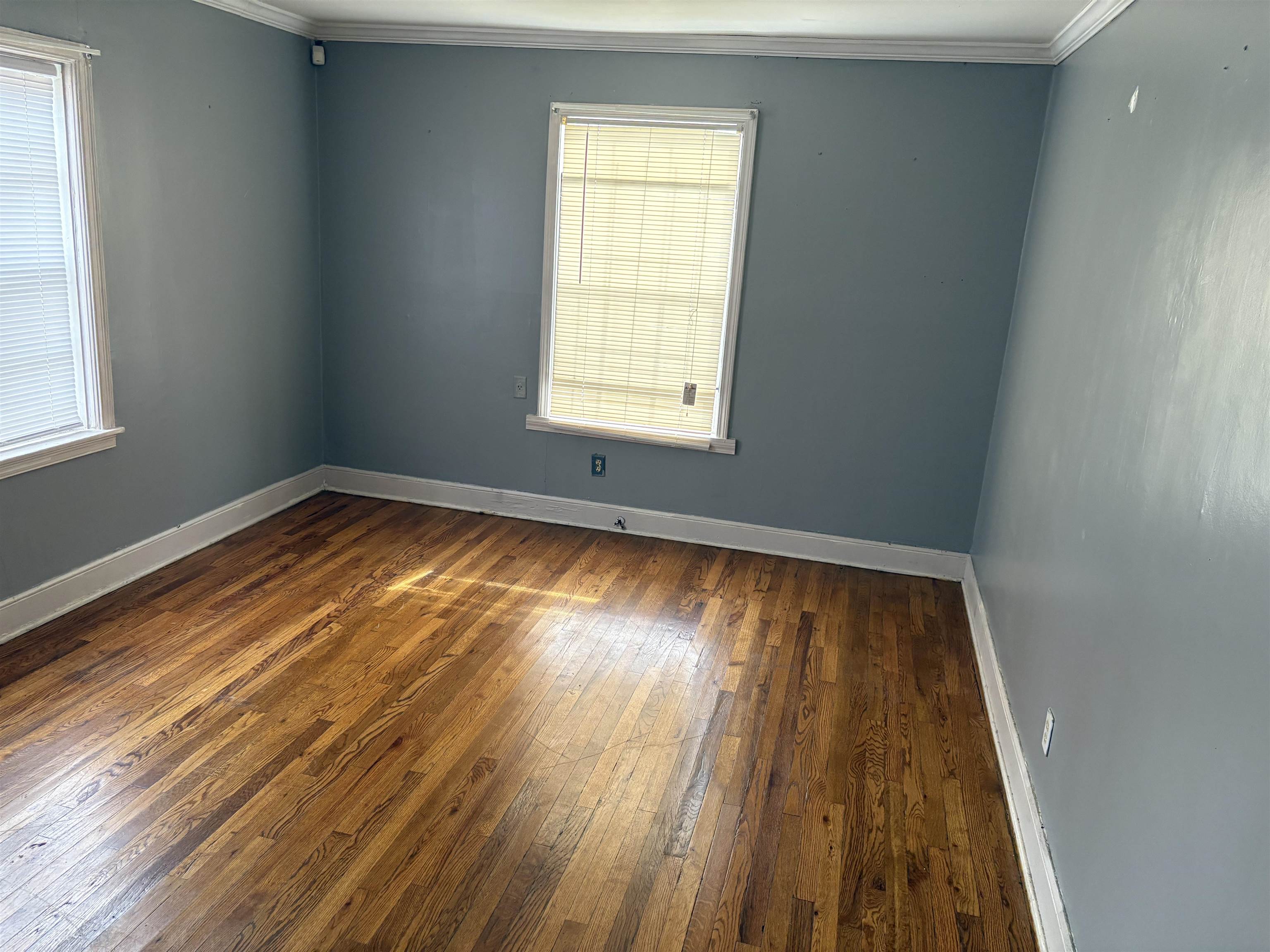 1509 Ragan Street Memphis, TN 38106 - Photo 3 of 17 Spare room with ornamental molding and dark wood finished floors
